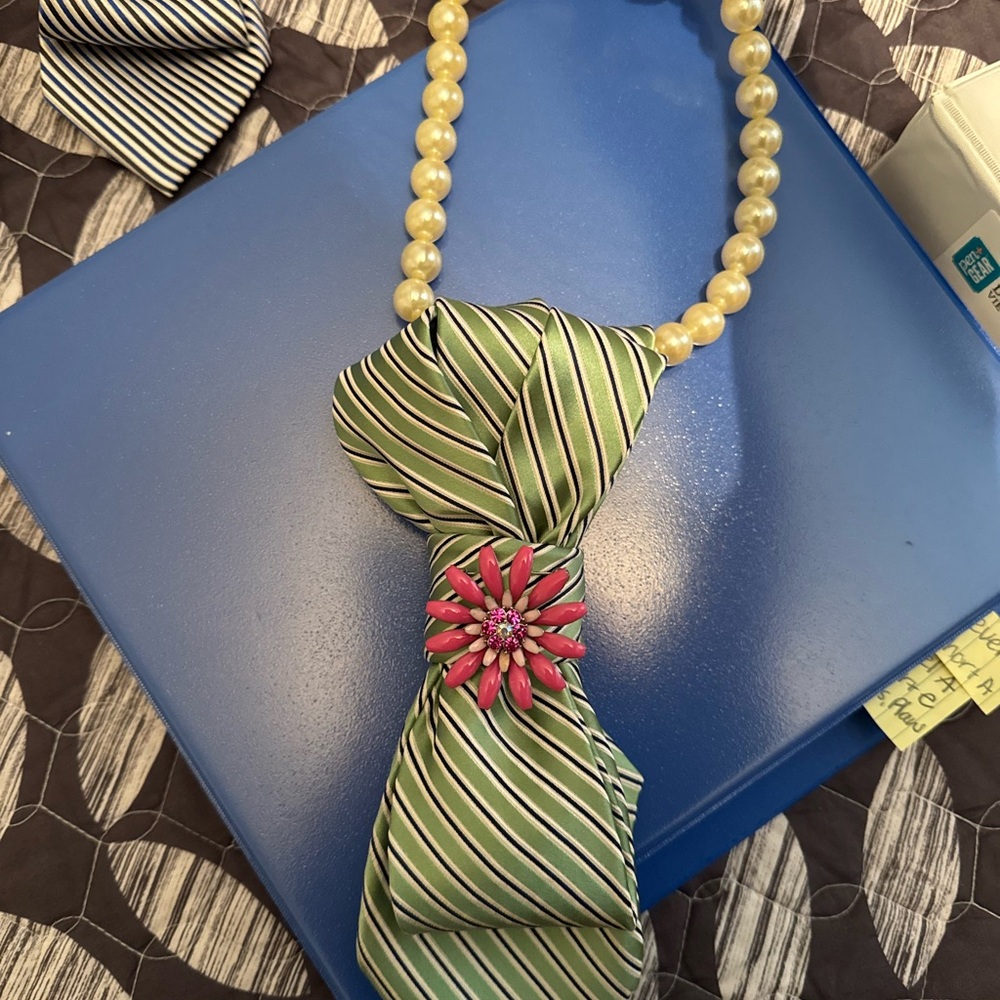 Green Striped Tie with Pink Brooch